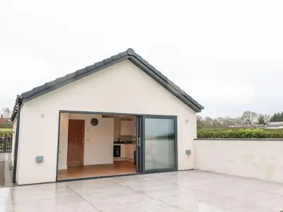a white house with a large glass door at ViewLangho in Blackburn