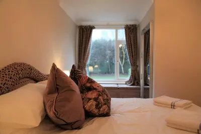 a bedroom with a bed with pillows and a window at The Farmhouse at Ream Hills in Weeton
