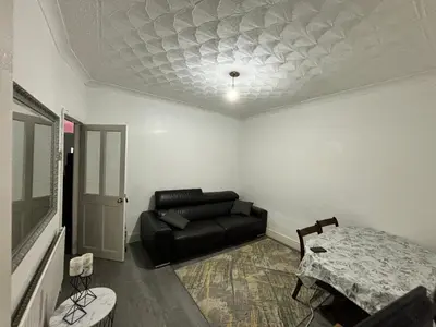 a living room with a couch and a table at Entire 3 Bedroom House- FREE PARKING in Liverpool