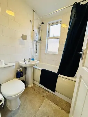 a bathroom with a toilet and a sink and a tub at Entire 3 Bedroom House- FREE PARKING in Liverpool