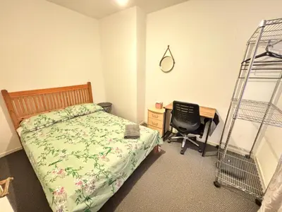 a bedroom with a bed and a desk and a ladder at Entire 3 Bedroom House- FREE PARKING in Liverpool