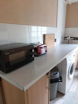 a kitchen with a counter with a microwave on it at Lovely 2 bedroomed flat in the centre of Longton in Longton