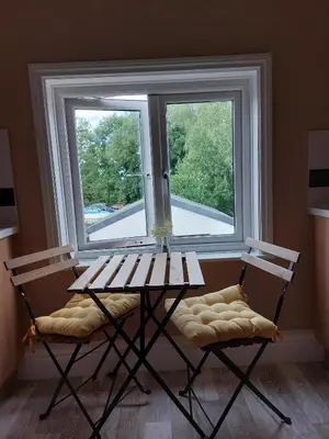 a table and two chairs in front of a window at Lovely 2 bedroomed flat in the centre of Longton in Longton