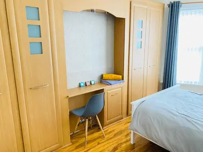 a bedroom with a desk and a chair next to a bed at Entire 4 bedroom House - EV POINT & FREE PARKING in Liverpool