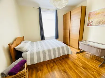 a small bedroom with a bed and a window at Entire 4 bedroom House - EV POINT & FREE PARKING in Liverpool