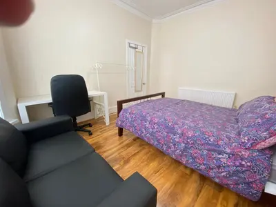 a bedroom with a bed and a couch and a chair at Entire 4 bedroom House - EV POINT & FREE PARKING in Liverpool
