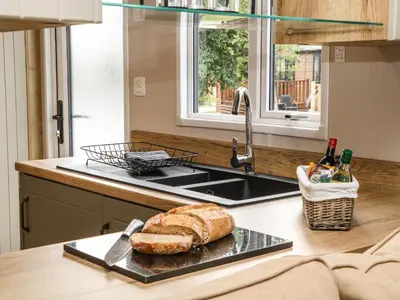 a loaf of bread on a tray next to a sink at Hedgehog Lodge in Carnforth
