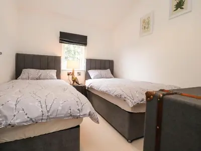 a bedroom with two beds and a window at Henry Haven in Preston