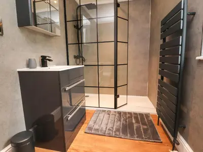a bathroom with a sink and a glass shower at Henry Haven in Preston