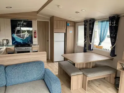 a kitchen and dining room with a table in a caravan at Blackpool caravans Marton mere in Blackpool
