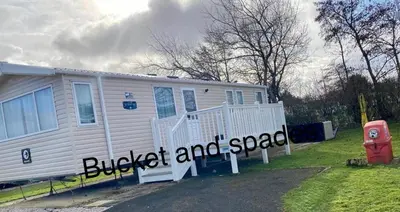 a house with a sign in front of it at Blackpool caravans Marton mere in Blackpool