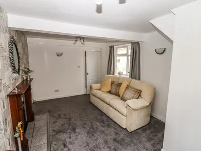 a living room with a couch and a window at 8 Heatons Bridge Road in Ormskirk