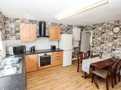 a kitchen and dining room with a table at 8 Heatons Bridge Road in Ormskirk