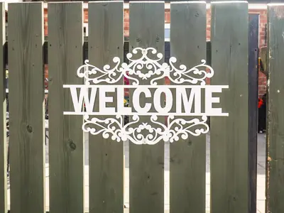 a welcome sign on a fence with the word welcome at 8 Heatons Bridge Road in Ormskirk