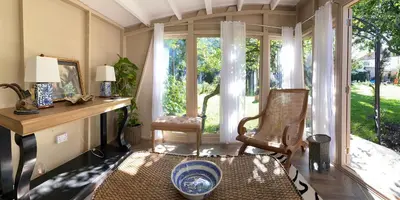 a living room with a chair and a window at Lyndhurst - Victorian villa with heated pool in Roby