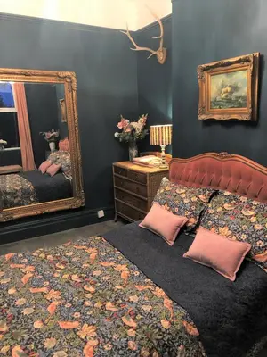 a bedroom with a bed and a mirror at Lyndhurst - Victorian villa with heated pool in Roby