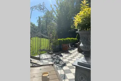 a view of a patio with plants and a fence at Lyndhurst - Victorian villa with heated pool in Roby