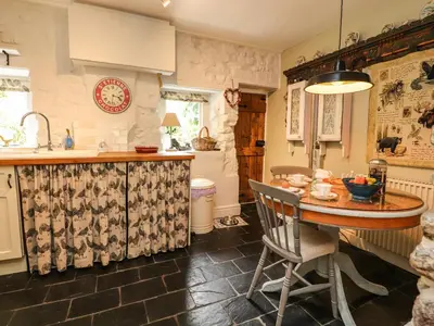 a kitchen with a table and a counter top at Duckdown in Clitheroe