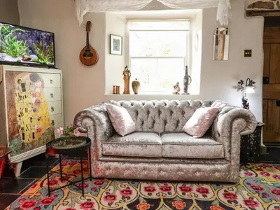 a living room with a couch and a window at Duckdown in Clitheroe