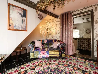 a living room with a chair and a rug at Duckdown in Clitheroe