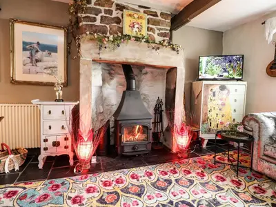 a living room with a fireplace with red lights at Duckdown in Clitheroe