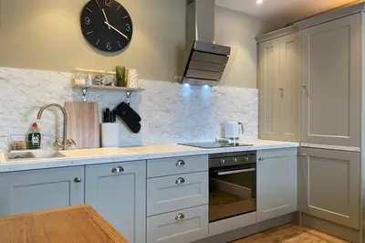 a kitchen with a clock on the wall and a sink at Mayfield Apartment Luxury first floor 1 bedroom apartment in Great Eccleston