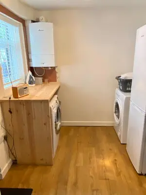 a kitchen with a washer and dryer in a room at Riverside Cottage in Whalley
