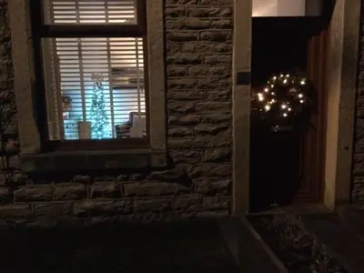 a christmas tree in the window of a house at Riverside Cottage in Whalley