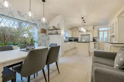 a kitchen and dining room with a table and chairs at Blackpool Abode - Southlands in Blackpool