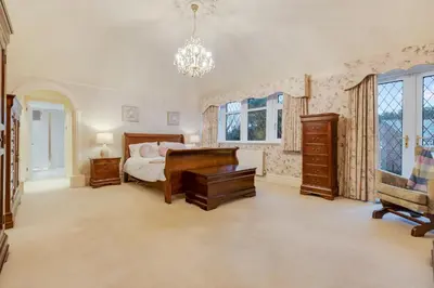 a bedroom with a bed and a desk at Blackpool Abode - Southlands in Blackpool