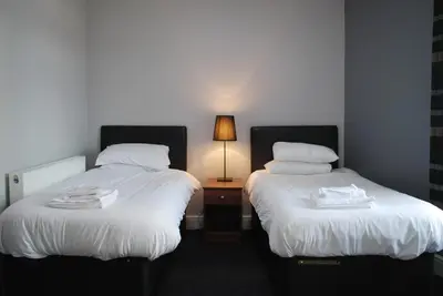 two beds sitting next to each other in a room at The Liverpool Inn Hotel in Liverpool
