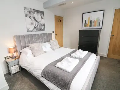 a bedroom with a bed with white sheets and pillows at Box Tree Farm House in Lancaster