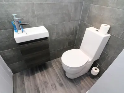 a bathroom with a white toilet and a sink at Box Tree Farm House in Lancaster