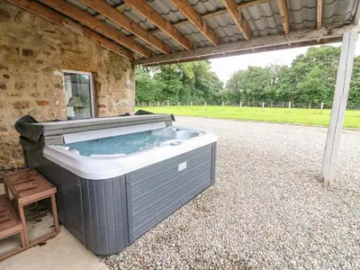 a hot tub sitting inside of a building at Box Tree Farm House in Lancaster