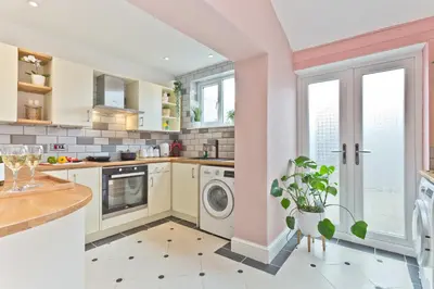 a kitchen with a washing machine and a dishwasher at Malleus House in Barrow in Furness