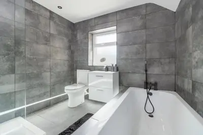 a bathroom with a tub and a toilet and a sink at TWO BED Modern Apartment 5min walk to Town centre with Free Parking ! Under New Management in Blackpool