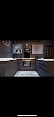 a large kitchen with white counters and appliances at TWO BED Modern Apartment 5min walk to Town centre with Free Parking ! Under New Management in Blackpool