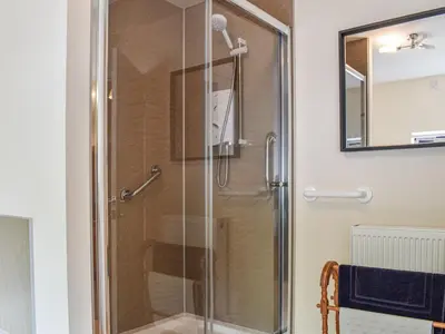 a shower with a glass door in a bathroom at 8 Lowther Gardens in Grange Over Sands