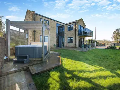 a house with a hot tub in the yard at Dewhurst Farm in Langho