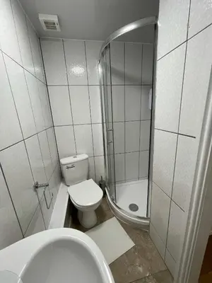 a white bathroom with a toilet and a shower at CityStays Rooms with Free Parking in Liverpool