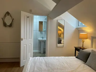 a bedroom with a bed and a sink and a mirror at CityStays Rooms with Free Parking in Liverpool