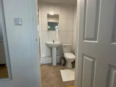 a small bathroom with a toilet and a sink at CityStays Rooms with Free Parking in Liverpool