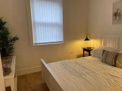 a bedroom with a white bed and a window at CityStays Rooms with Free Parking in Liverpool