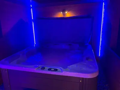 a bath tub with a purple light in a room at BREEZE SUITES - LUXURY GROUP ACCOM - SLEEPS 19 in Blackpool