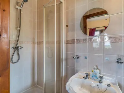 a bathroom with a sink and a shower at Highfield Cottage in Poulton le Fylde