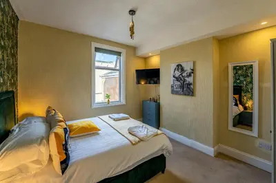 a bedroom with a bed and a window at Blackpool Abode - The Cinema House in Blackpool