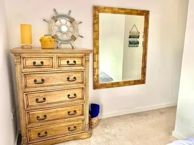 a dresser with a mirror next to a dresser at Lovely 2 bedroom modern loft apartment sea view in Morecambe