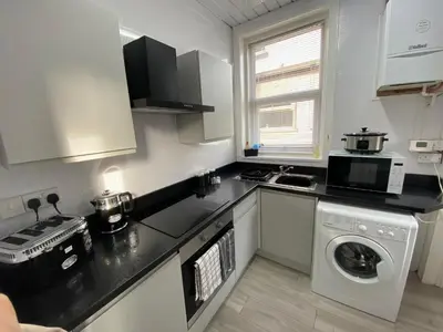 a kitchen with a washing machine and a washer at Blackpool Abode - 124 Elite Apartments in Blackpool
