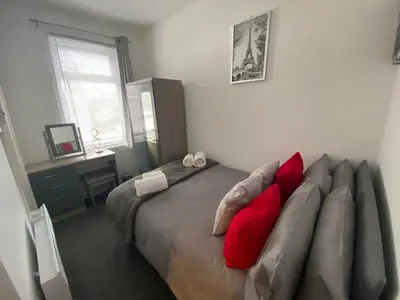 a bedroom with a bed with red pillows on it at Blackpool Abode - 124 Elite Apartments in Blackpool