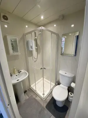 a bathroom with a shower and a toilet and a sink at Blackpool Abode - 124 Elite Apartments in Blackpool